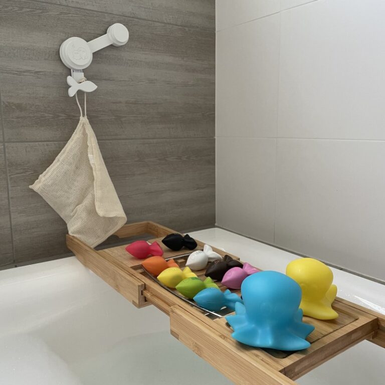 Final Models of Koa's Adventure sitting on a wooden board over a bath tub filled with bubbles. 